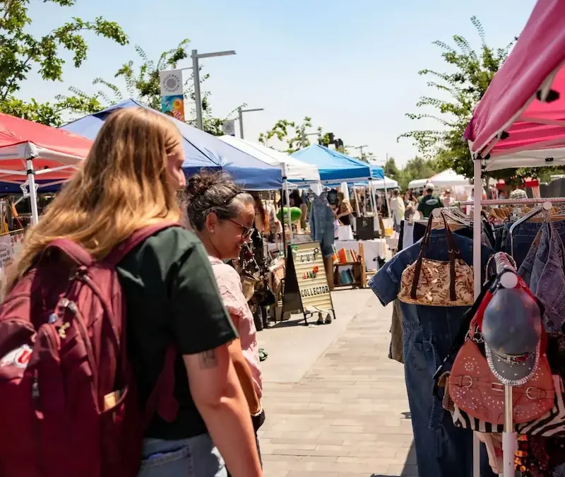 Shoppers browsing booths at The Summer Bazaar at Millcreek Common