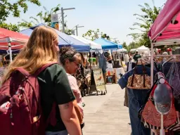 Shoppers browsing booths at The Summer Bazaar at Millcreek Common
